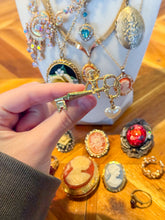 Load image into Gallery viewer, 1928 Cherub Sitting on a Key Brooch with Faux Pearl from London

